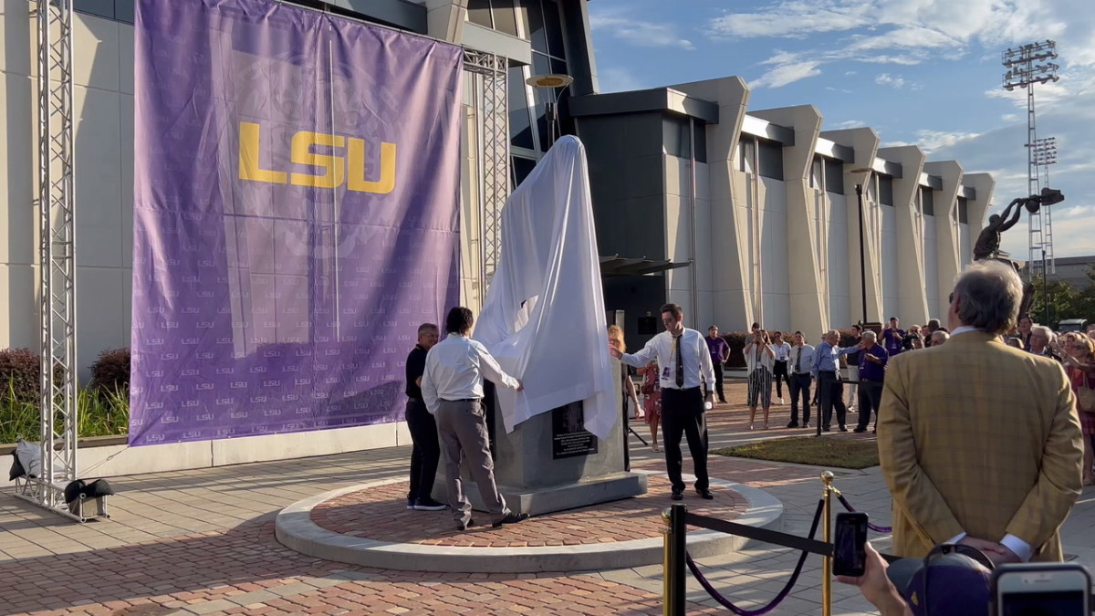Pete Maravich's family prepares to unveil his statue on July 25, 2022. His two sons, Jaeson and Josh, accompanied Maravich's wife Jackie. 